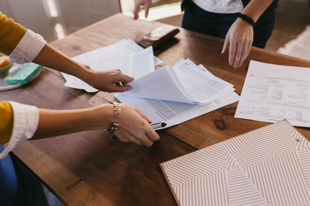 Desk with paperwork, calculating the costs of private school fees