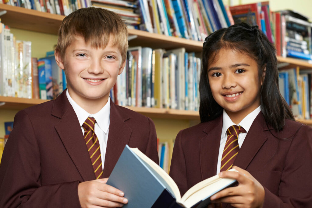 Two school children reading in a library