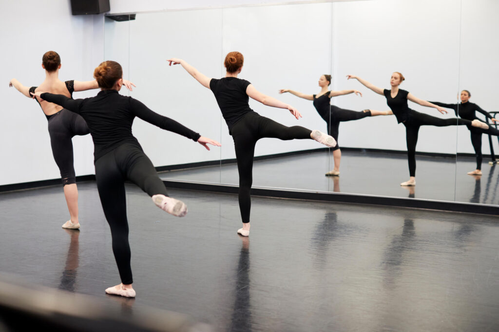 Dancers in a mirrored dance studio
