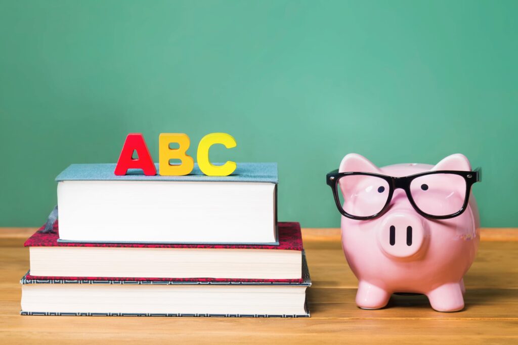 A pile of books and a piggy bank.